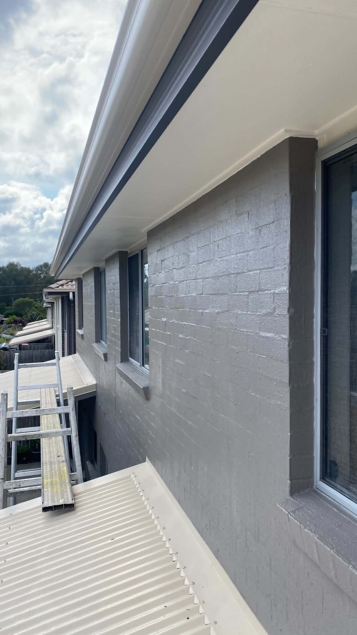 Charcoal exterior render coating with UV-resistant membrane in Southport