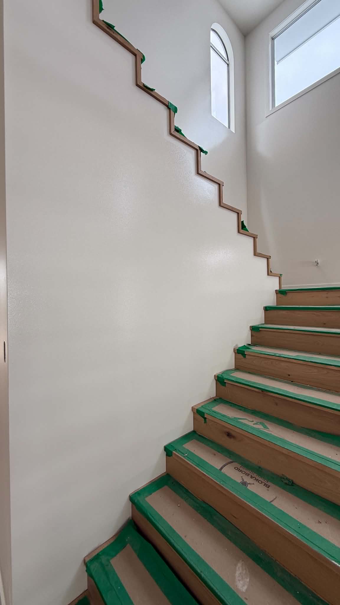 Double-height interior stairwell painting with precision cut-ins in Mount Gravatt
